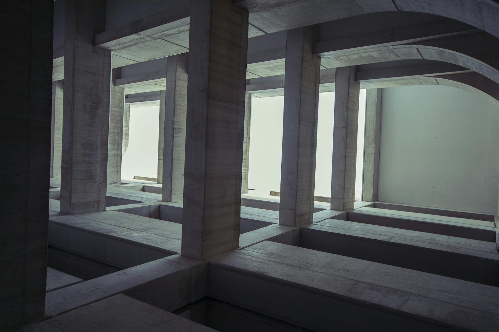 A minimalist architectural space with modern concrete columns in an unfinished building.